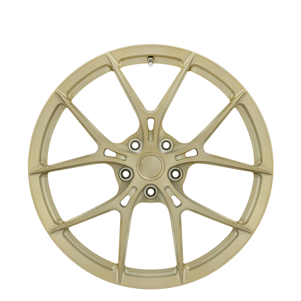Gold twin spoke forged alloy wheel on white background