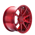 Red 8 spoke forged alloy wheel on white background