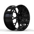 Black forged alloy wheel on white background.