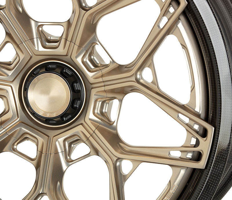 Gold carbon barrel forged alloy wheel on white background