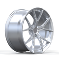 Silver twin spoked design forged wheel on white background.