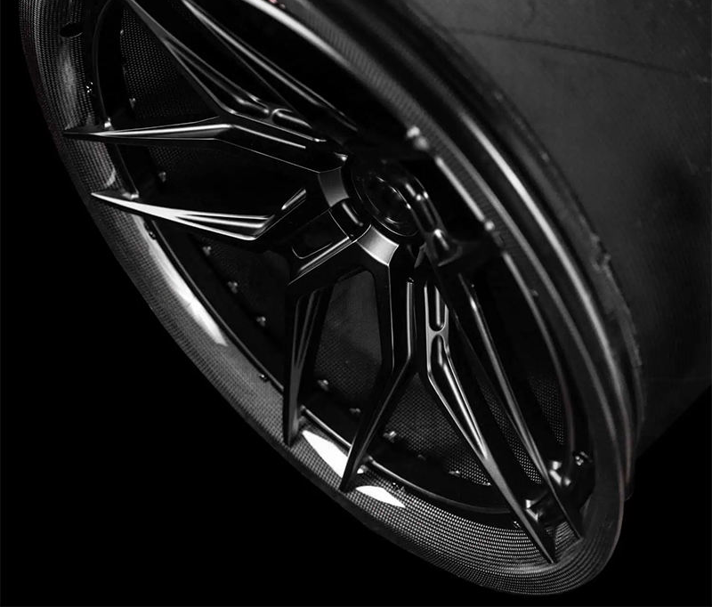 Black carbon barrel forged alloy wheel on white background