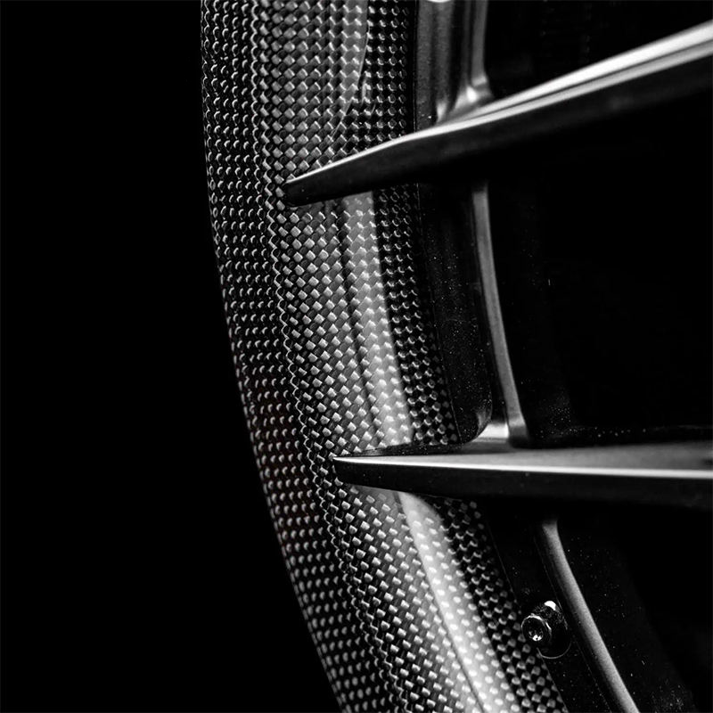 Black carbon barrel forged alloy wheel on white background