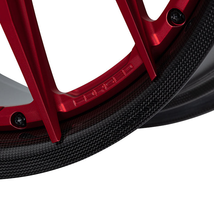 Red carbon barrel forged alloy wheel on white background